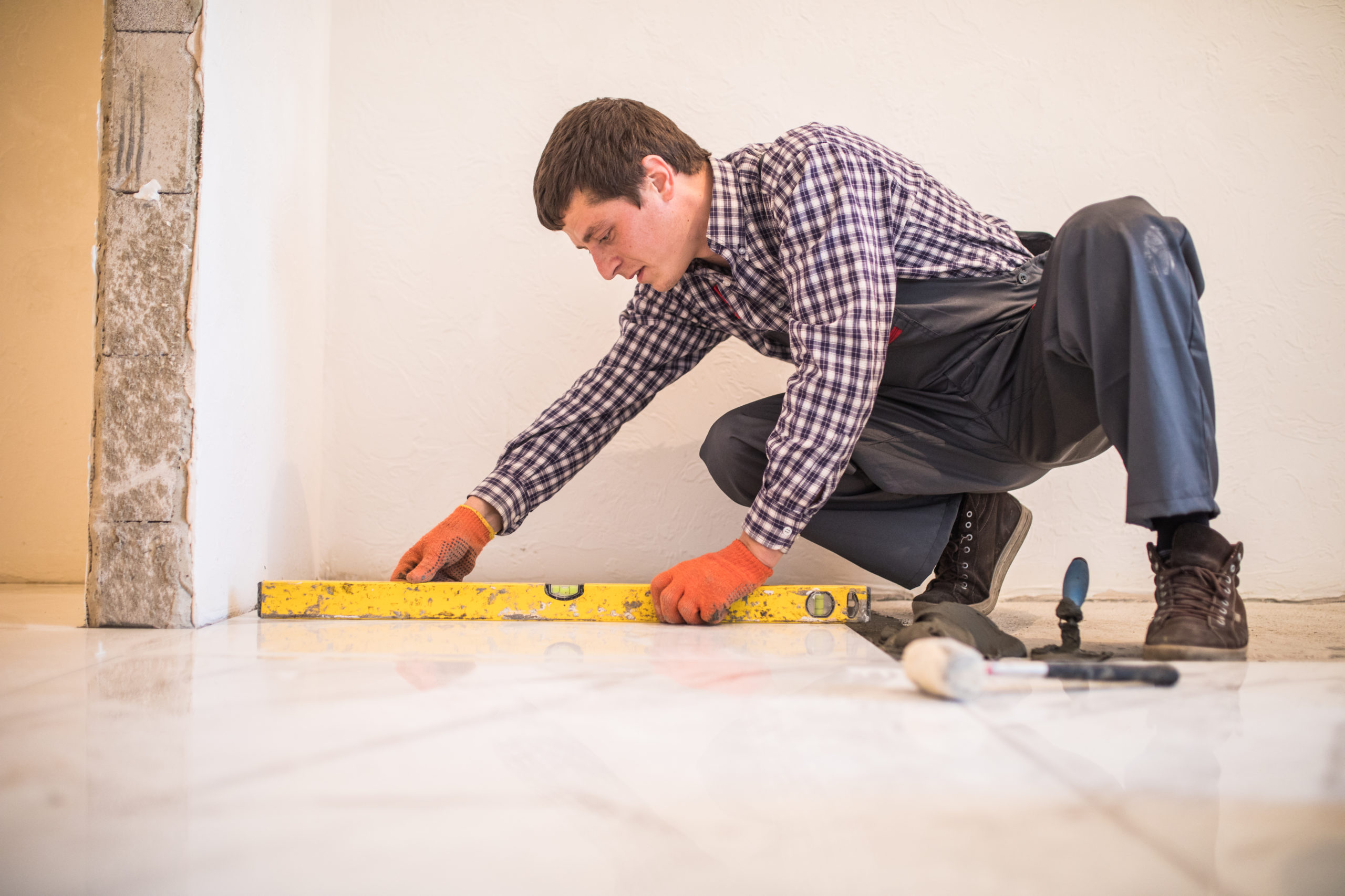 Handyman leveling tile floor